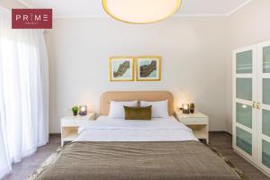 a bedroom with a large bed and two night stands at Prime Select Palm Hills - The Crown in Abū Rawwāsh