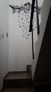a stairwell with a staircase with a wall with butterflies at Maganal in Villa Carlos Paz