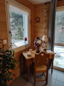 a small table in a room with a window at chalet des pierres opalines in Xonrupt-Longemer