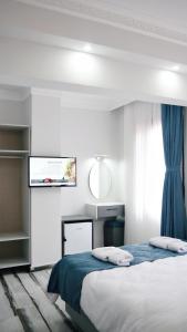 Postel nebo postele na pokoji v ubytování Nefis Hotel City