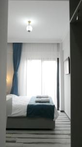 Postel nebo postele na pokoji v ubytování Nefis Hotel City