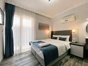 Postel nebo postele na pokoji v ubytování Nefis Hotel City