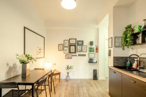 a kitchen and dining room with a table and chairs at GARDEN HOUSE - Luxury Guest House - Self check-in only in Rome +34 photos