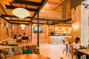 a restaurant with people sitting at tables and a bar at Villa Saint Exupery Beach Hostel in Nice