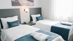 Postel nebo postele na pokoji v ubytování Nefis Hotel City