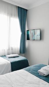 Postel nebo postele na pokoji v ubytování Nefis Hotel City