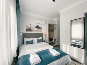 Postel nebo postele na pokoji v ubytování Nefis Hotel City