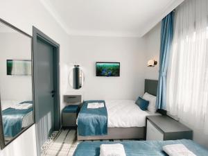 Postel nebo postele na pokoji v ubytování Nefis Hotel City