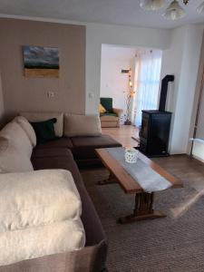a living room with a couch and a coffee table at Holiday Home Smiljan in Gospić