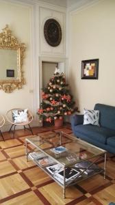 a living room with a christmas tree and a table at B&B Palazzo Bianchi in Parma