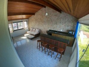 a view of a kitchen and a living room at Guaraflat in Guaratuba