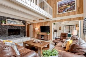 a living room with leather furniture and a fireplace at Golf Home 53 in Black Butte Ranch