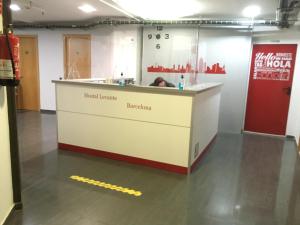 a reception counter in a building with the words hotel khamenei at Hostal Levante Barcelona in Barcelona