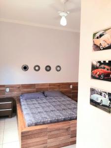 a bedroom with a bed and some clocks on the wall at ESPAÇO FONDER in Caldas Novas