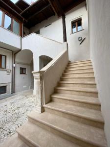 a set of stairs in a building with a door at La suite aquilana in LʼAquila