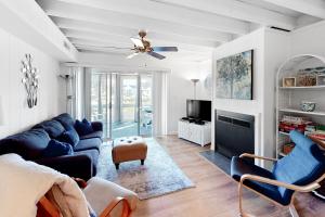 a living room with a blue couch and a ceiling fan at Mallard Lakes -- 38243 Cardinal #115 in Selbyville