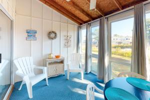 a room with white chairs and a table and windows at Mallard Lakes -- 38243 Cardinal #115 in Selbyville