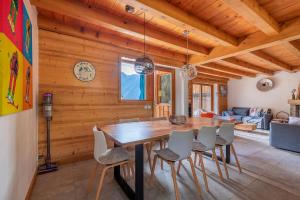 a dining room with a wooden table and chairs at Chalet Solize - Terrasse avec superbe vue - Sauna in Champagny-en-Vanoise