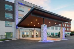 a building with awning and lights in a parking lot at Holiday Inn Express & Suites - Bourbonnais East - Bradley by IHG in Bourbonnais