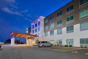 a car parked in a parking lot in front of a hotel at Holiday Inn Express & Suites - Bourbonnais East - Bradley by IHG in Bourbonnais