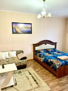 
Кровать или кровати в номере Проспект Вячеслава Клыкова 83
