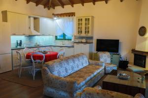 a living room with a couch and a kitchen at Country Home Giannaras in Piána