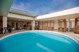 a hotel room with a pool and a pool table at Like U Hotel Brasília in Brasília