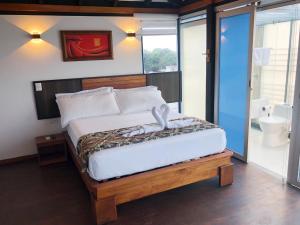 Postel nebo postele na pokoji v ubytování La Bocana de Quiximies Hotel