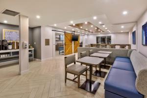 a restaurant with tables and chairs and a bar at Staybridge Suites Pittsburgh Airport by IHG in Beechcliff
