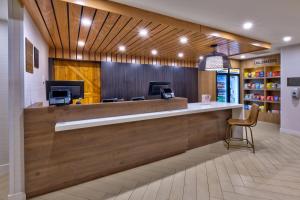 a lobby of a store with a counter and a chair at Staybridge Suites Pittsburgh Airport, an IHG Hotel in Pittsburgh