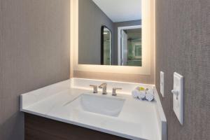 a bathroom with a white sink and a mirror at Staybridge Suites Pittsburgh Airport by IHG in Pittsburgh +42 photos