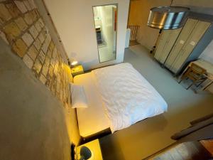 a small bedroom with a bed and a mirror at König Albert Industrie Loft in Bitterfeld