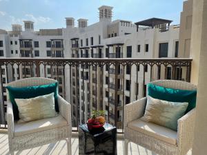 two chairs on a balcony with a view of a building at Madinat Jumeirah Living in Dubai