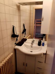a bathroom with a sink and a mirror at relax @the beach in De Haan +23 photos