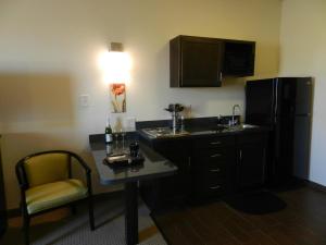 a room with a kitchen with a desk and a refrigerator at Black Gold Suites in Tioga