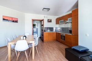 a kitchen and dining room with a table and chairs at Panorama Apartment - Happy Hours in Sopot