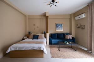 a bedroom with a bed and a blue couch at Studio Dieci in Drama