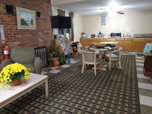 a living room with a table and chairs and a kitchen at Grandview Plaza Inn in Junction City