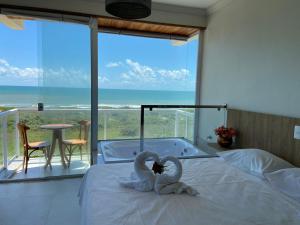 a bedroom with a tub and swans made out of towels at ATLANTIC MARLIN HOTEL in Guriri