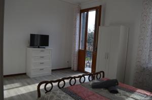 a bedroom with a bed and a tv and a window at Noemi Venice Home in Marghera