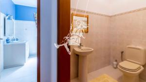 a bathroom with a toilet and a sink at Chalé Davim com piscina -Tranquilidade e conforto in Louriçal +22 photos