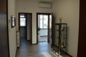 a hallway with two doors and a shelf with plants at Noemi Venice Home in Marghera