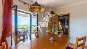 a dining room with a table with a bowl of fruit on it at Chalé Davim com piscina -Tranquilidade e conforto in Louriçal