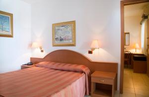 a bedroom with a bed in a hotel room at Garden Hotel Ripa in Vieste