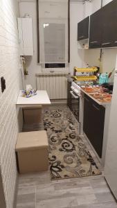 a small kitchen with a counter and a stove at Apartament Ella ,wifi inclus la Straja ,Lupeni ! in Lupeni