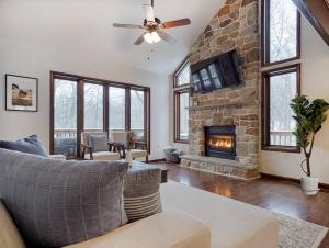 a living room with a couch and a fireplace at Highland House: Lakefront, Hot Tub, Views, Private in East Stroudsburg