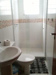 a bathroom with a sink and a toilet and a shower at Boulevard Bed & Breakfast in Rio de Janeiro