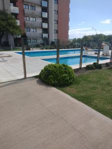 a swimming pool in front of a building at Departamento Avani, nuevo A ESTRENAR, GIMNASIO Y SUM in Cordoba