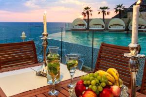a table with a bowl of fruit and wine glasses at Apartment Your Home in Dobra Voda