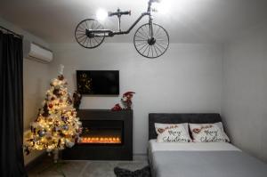 a bedroom with a christmas tree and a bike hanging over a fireplace at Reef Terrace Apartments in Yaremche +44 photos